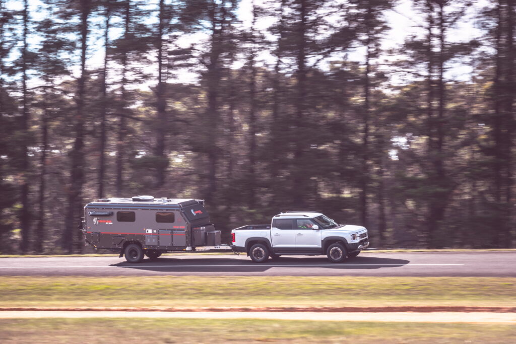 BYD Shark 6 Performance towing camper on highway