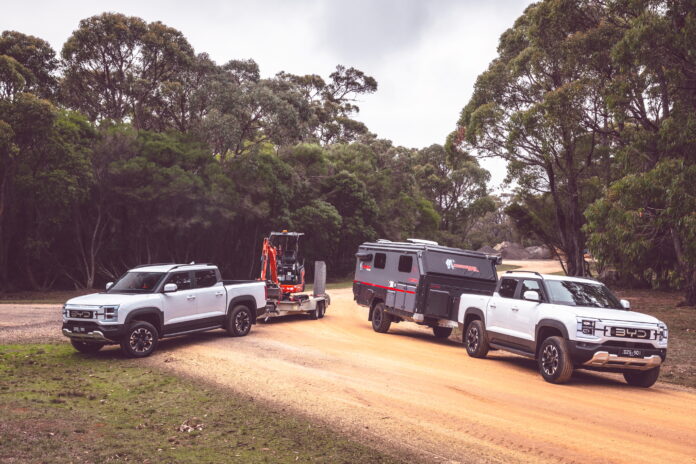 Two trucks with trailer in nature